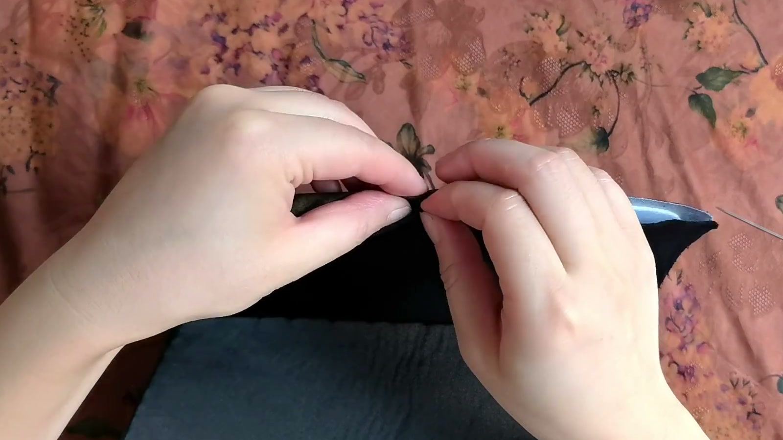With the flap held in its closed curve, two hands align the center marks on the outer batting and lining interfacing