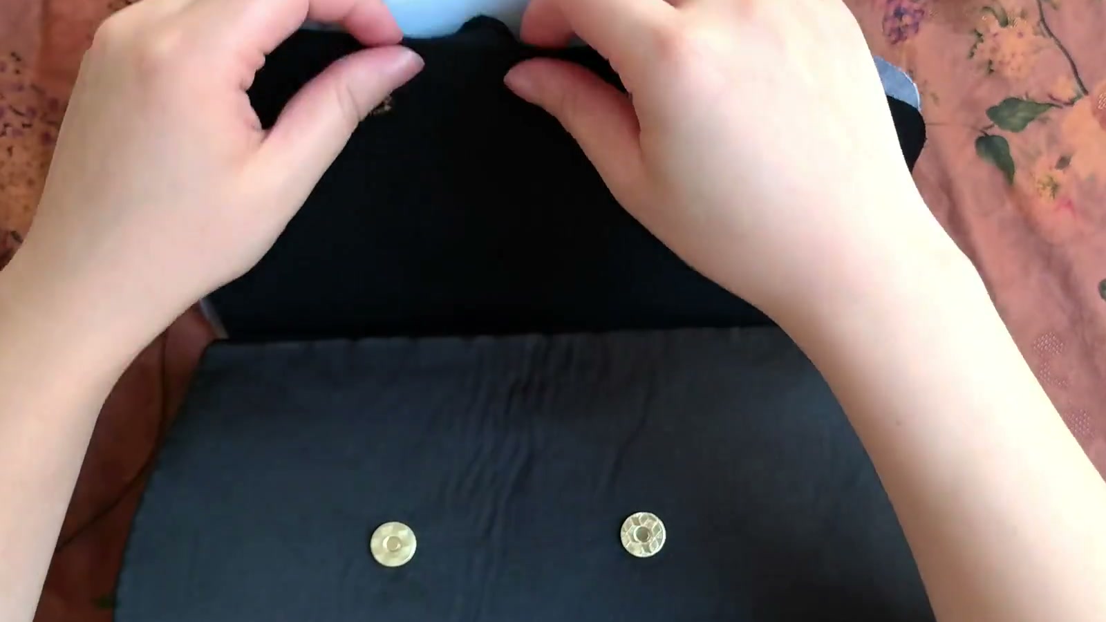 A finger shows that the stiff interfacing on the lining side of the flap ends below the white outer batting
