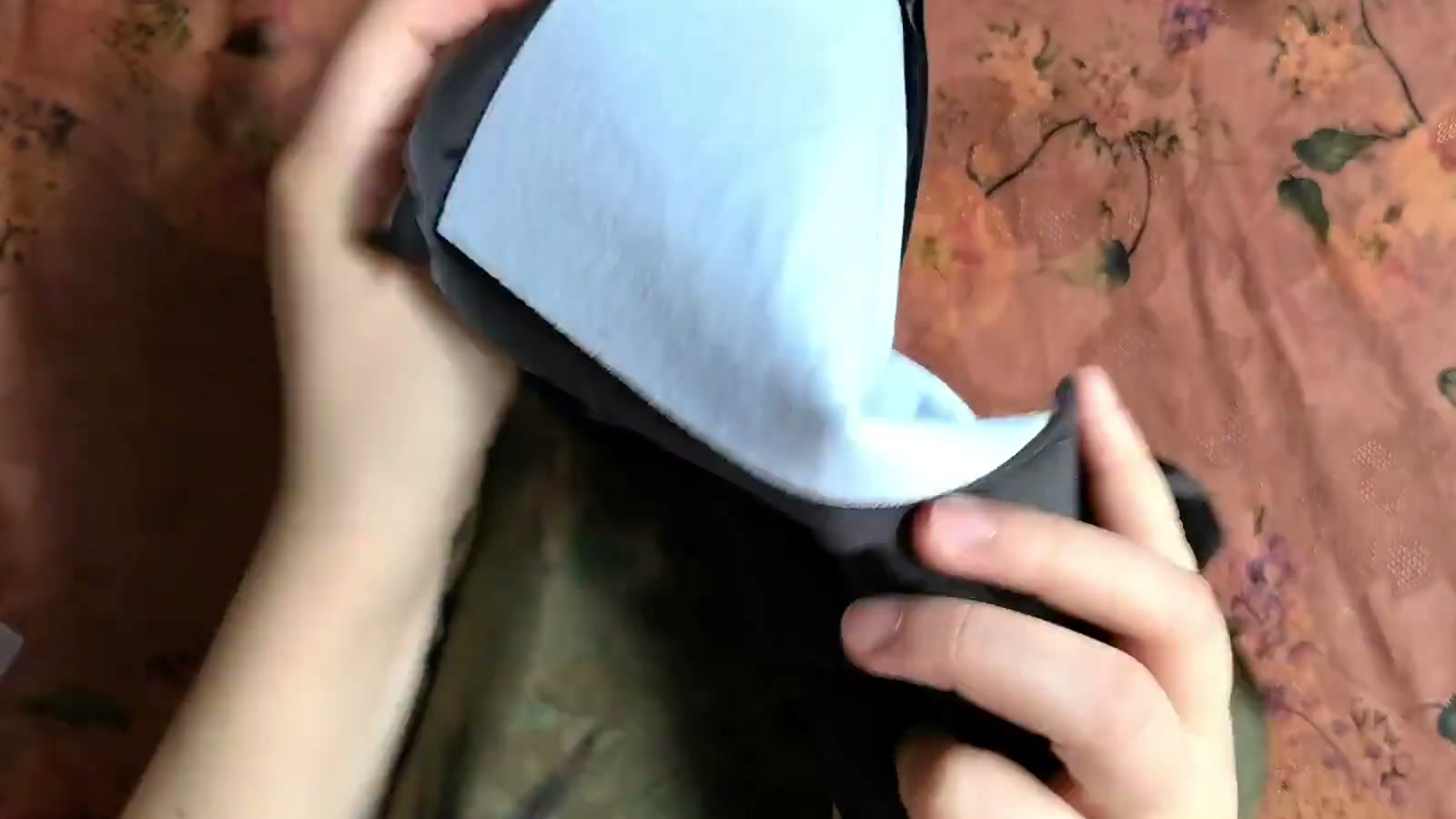Two hands turn the completed outer shell right side out through the open top