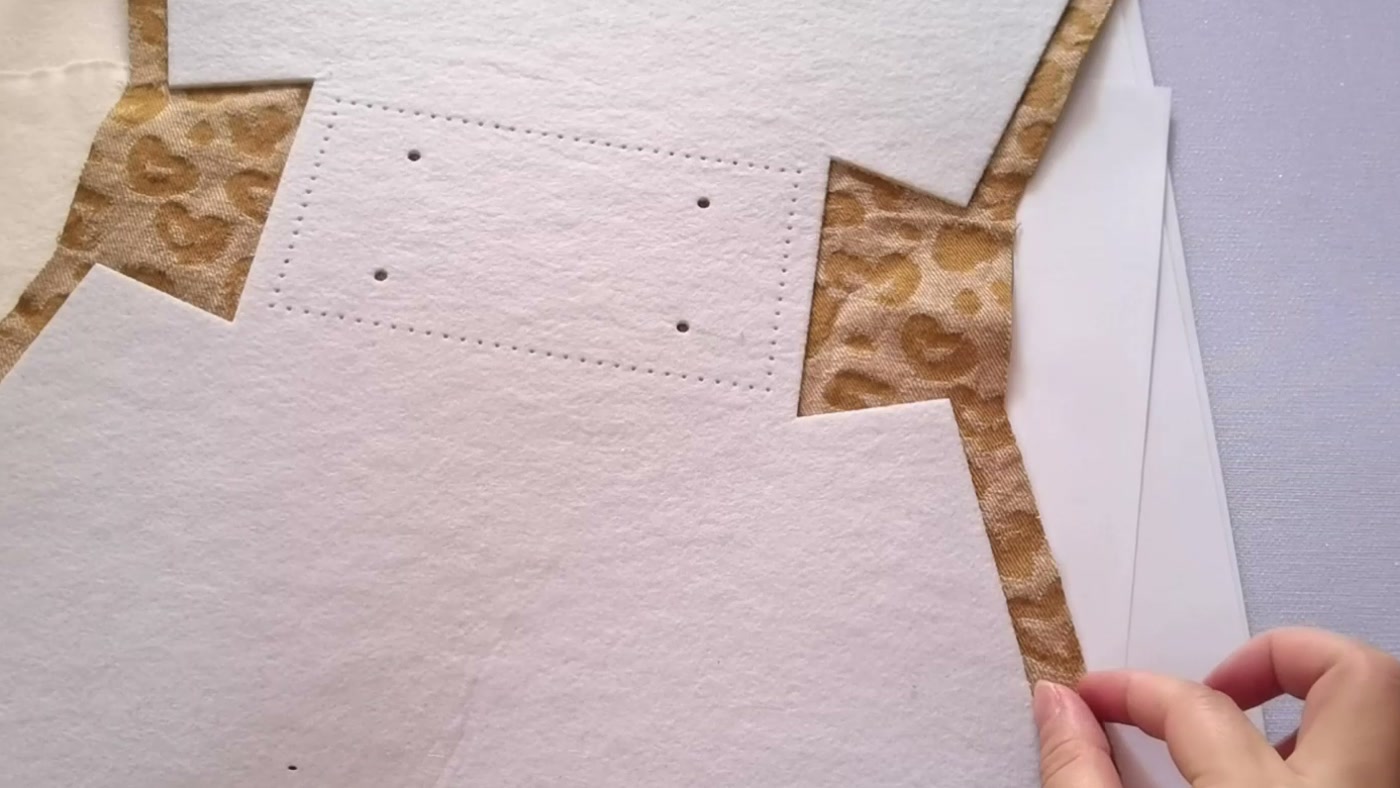 White batting fused to printed outer fabric, with the fabric extending beyond the complete batting outline